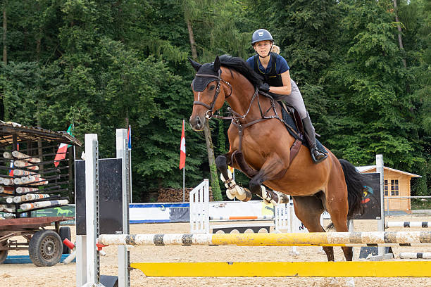 istock Female show jumper on brown mare. 2251836898