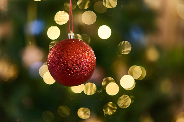 istock Decorative Red Bauble Displayed In Festive Shop Window Setting Highlighting Seasonal Illumination 2251837076