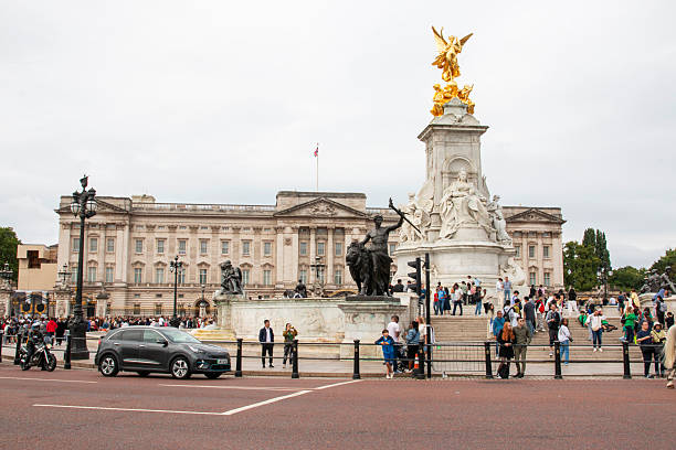 London, England - 7 August 2025: People walk and take pictures near the statue at Buckingham Palace in London.