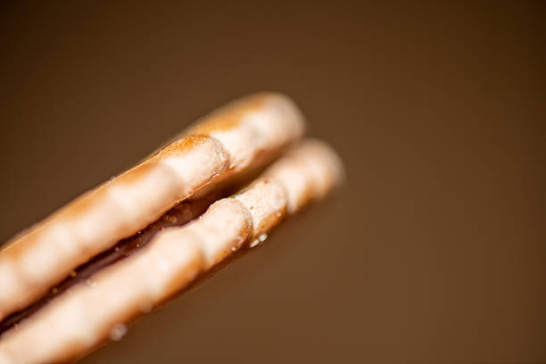 A close-up shot of golden Bavarian pretzels displayed in a bakery section with shoppers in the background, emphasizing freshness and delicious food options available in the store