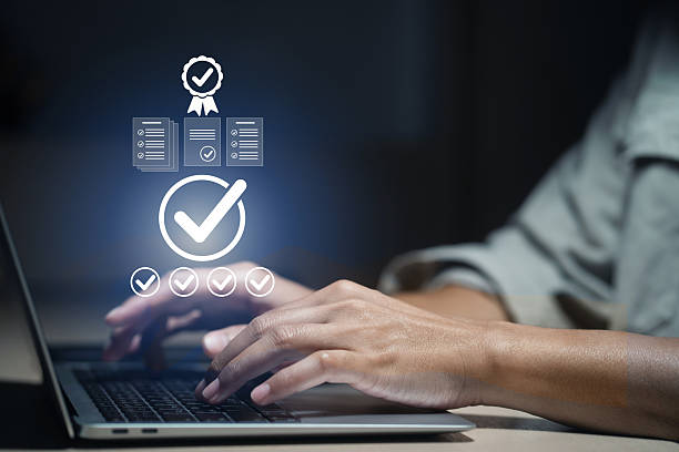 istock Man checking quality assurance compliance and guaranteed service standard on virtual screen. Successful management systems, ISO certification, company audit, product quality control 2251842555
