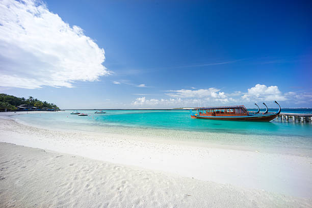 istock Dhoni Boat White Sand Beach 2251842735