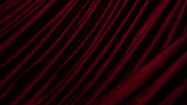 istock Luxurious red velvet fabric drapes elegantly, showcasing rich texture and depth. soft, plush surface creates warm and inviting atmosphere, perfect for adding sophistication to any setting 2251844891
