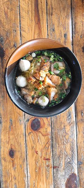istock Noodle soup in a ceramic bowl on a wooden table 2251846848