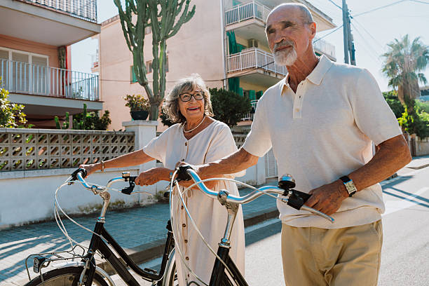 istock Happy senior couple walking bicycles enjoying active retirement 2251847394