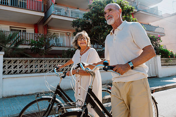 istock Happy senior couple walking bicycles enjoying active retirement 2251847404