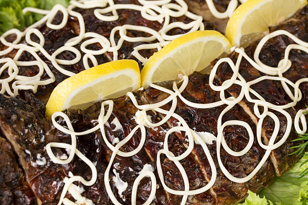 Closeup of baked sturgeon with greens and vegetables. Macro. Photo can be used as a whole background.