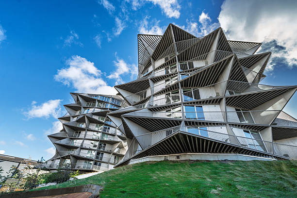 istock Futuristic Stacked Facade Towers Create Dynamic Skyline Behind Green Park in a Modern Setting With Bright Blue Sky, Cactus Towers, Esbjerg, Denmark 2251848358
