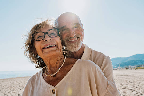 istock Senior couple hugging on sunny beach enjoying retirement 2251848642