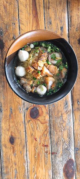 istock Noodle soup in a ceramic bowl on a wooden table 2251849296