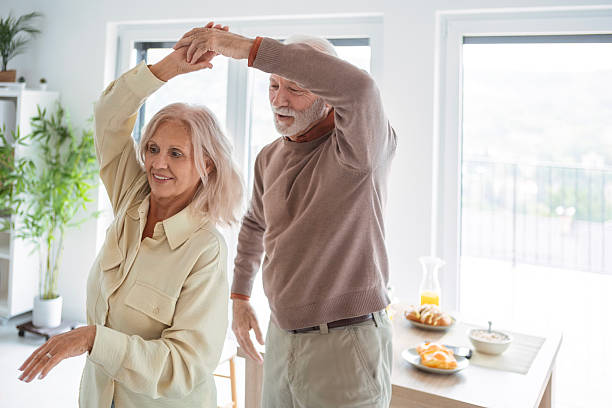 istock Romantic Elderly Couple Dancing at Home During Relaxed Morning 2251849470