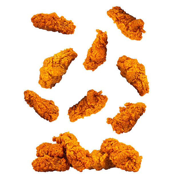 istock Spicy crispy fried chicken drumsticks isolated on white background fall splash 2251849541