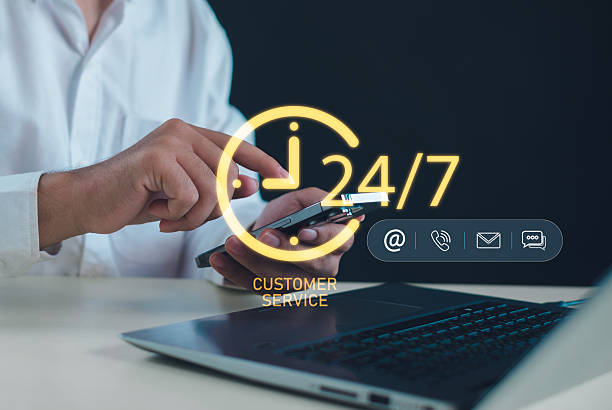 istock 24-7 customer service concept with a person using a smartphone and laptop, featuring digital communication icons that represent nonstop support, online assistance, and reliable client interaction. 2251850437