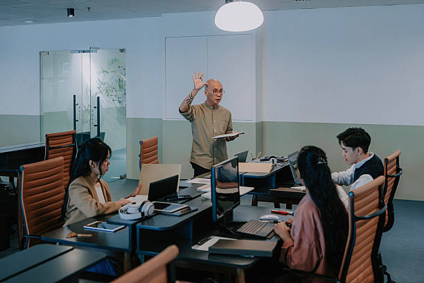 istock Asian Male Manager asking question to Team During Office Meeting 2251852592