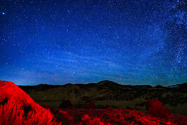 istock Stars at Night Mountain View with Red Light Painting 2251853805