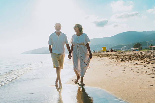 istock Senior couple walking on beach holding hands during vacation 2251853810