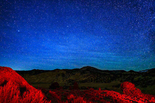 istock Stars at Night Mountain View with Red Light Painting 2251853835