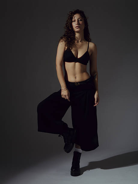 istock Confident young woman posing in black underwear in studio 2251854021