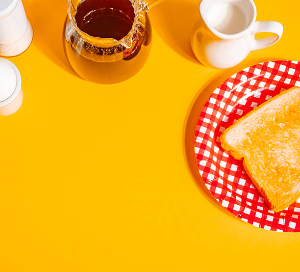 A cozy retro scene featuring a white coffee cup filled with black coffee on a yellow background, accompanied by a glass coffee pot, toasts, egg and a cream pitcher.