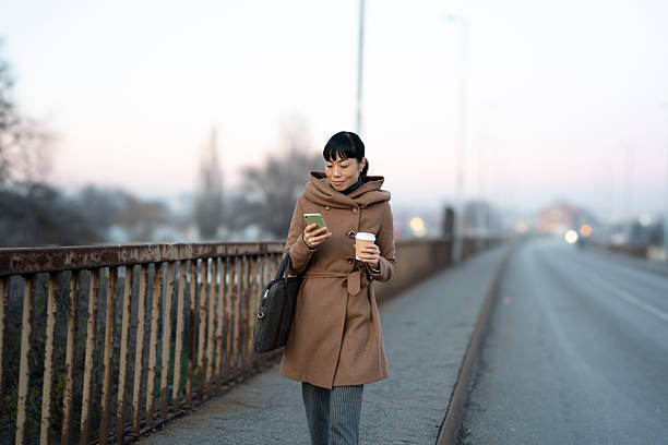 istock Woman walking on bridge commuting to work 2251856148