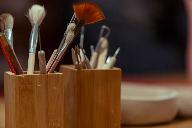 The box is full of jars of colorful paint and various brushes for creating beautiful artwork