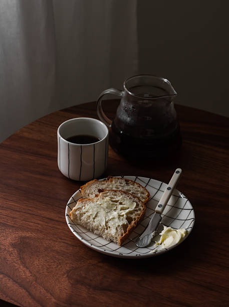 istock Breakfast table - black coffee, sourdough bread with butter on a wooden table 2251860633