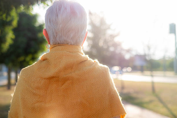 istock Senior woman walking outdoors on a sunny day 2251860796