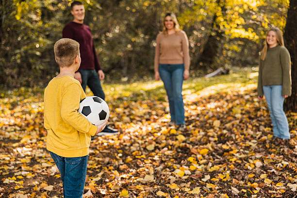 istock Family Playing With Ball At Park 2251863232