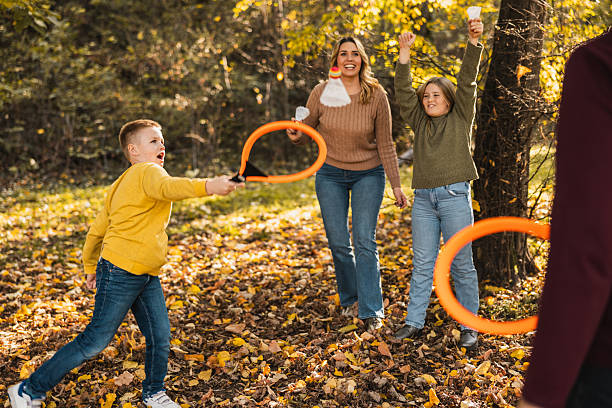 istock Family Playing Badminton In Park 2251863448
