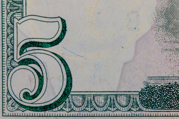 United states five dollar bill showing the number 5 detail and texture