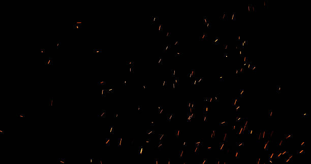 istock Fire sparks flying in the air, isolated on a black background. 2251876537
