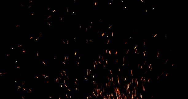istock Fire sparks flying in the air, isolated on a black background. 2251876661