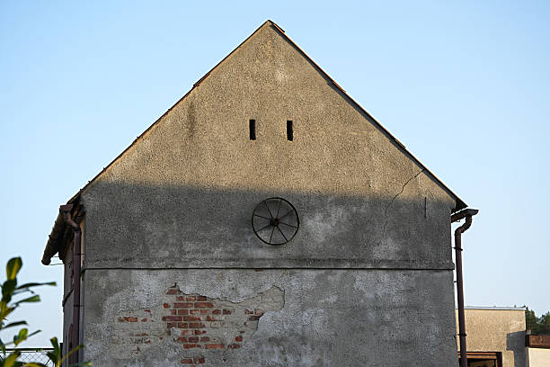 Old barn decorated with iron antique cart wheel