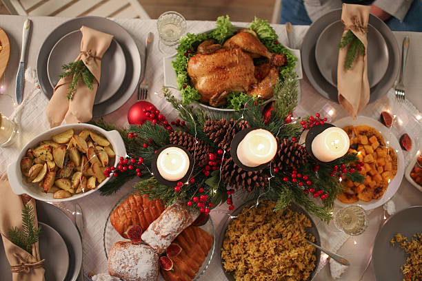 istock Christmas table with candles, drinks, pine branches and festive decor for holiday celebration 2251884205