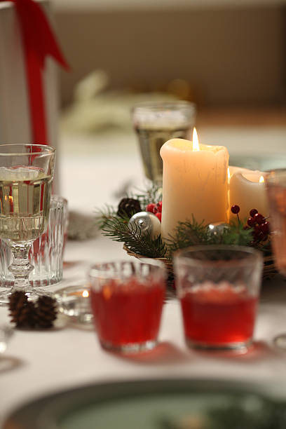 istock Christmas table with candles, drinks, pine branches and festive decor for holiday celebration 2251884386