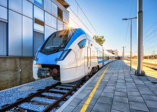 istock High-speed blue passenger train at railway station at sunset 2251891693