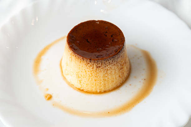 Egg flan with caramel sauce on white plate