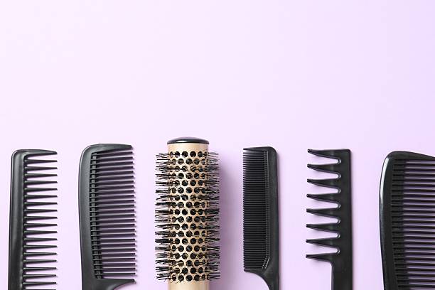 istock Professional combs and hairdresser tools on color background, top view 2251903508