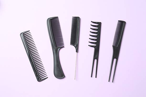 istock Professional combs and hairdresser tools on color background, top view 2251903510