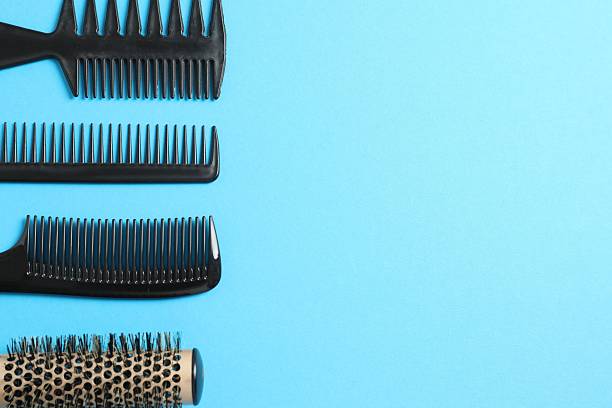 istock Professional combs and hairdresser tools on color background, top view 2251903596