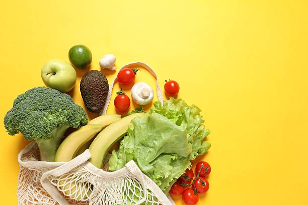 istock String bag with vegetables and fruits on color background 2251904219