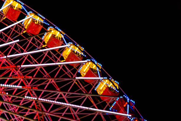 istock Ferris wheel. Bright lights out of focus. 2251905235