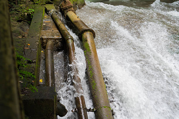 istock Mossy metal pipes in a fast flowing room 2251906920