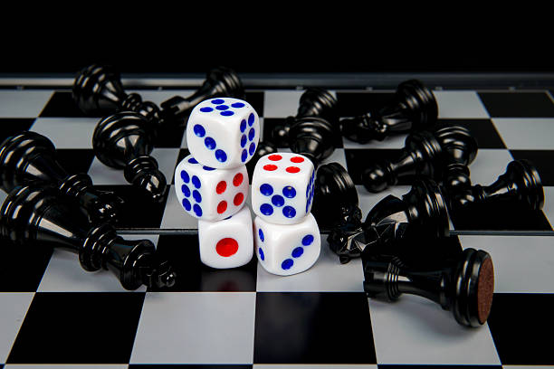 istock Dice on chessboard surrounded by fallen chess pieces representing risk, strategy, uncertainty, and decision making concept where chance and planning collide in competitive situations. 2251907592