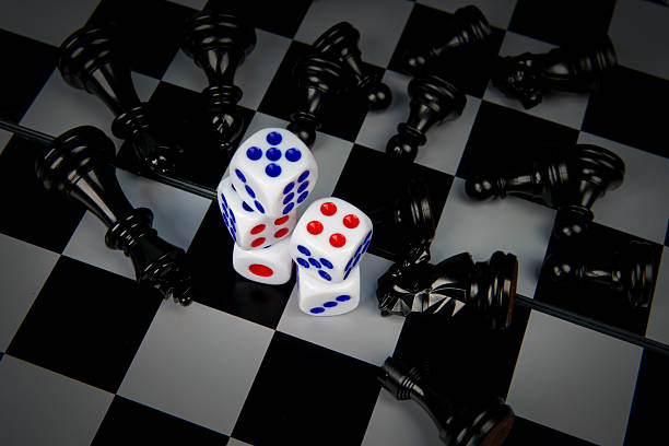 istock Dice on chessboard surrounded by fallen chess pieces representing risk, strategy, uncertainty, and decision making concept where chance and planning collide in competitive situations. 2251907614