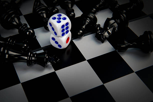 istock Dice on chessboard surrounded by fallen chess pieces representing risk, strategy, uncertainty, and decision making concept where chance and planning collide in competitive situations. 2251907641