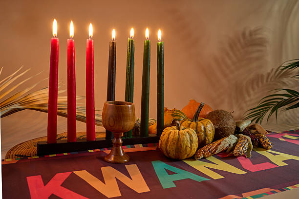 istock Kwanzaa Celebration Setup. Seven candles signify Kwanzaa with decorative gourds, corn, and vibrant tablecloth. 2251908174