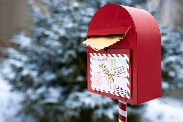 istock Festive Mailbox. A red mailbox with a letter to Santa in a snowy outdoor setting. 2251908659