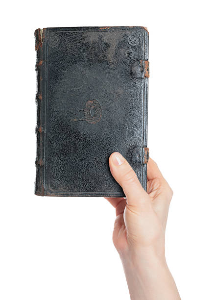 istock Hand holding an old antique book, isolated on transparent background. Ideal for education, history, literature, archival, and vintage-themed design projects 2251909443