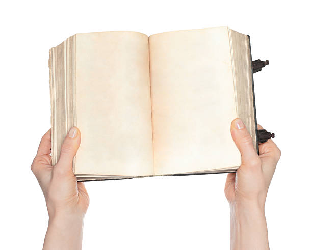 istock Hands holding an open ancient book with blank pages, isolated on transparent background. Ideal for education, history, literature, archival, and vintage-themed projects 2251909445